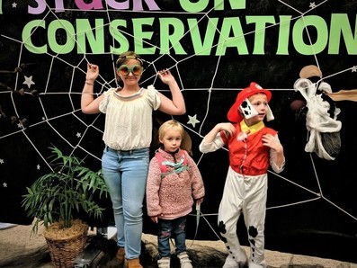 Three kiddos pose for Halloween photo at Cape Nature Center