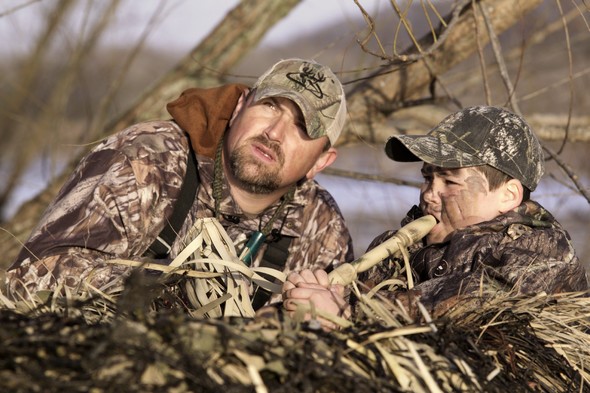 Father and son calling for waterfowl