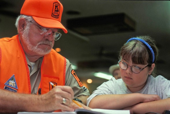 Hunter ed instructor helps girl with written exam