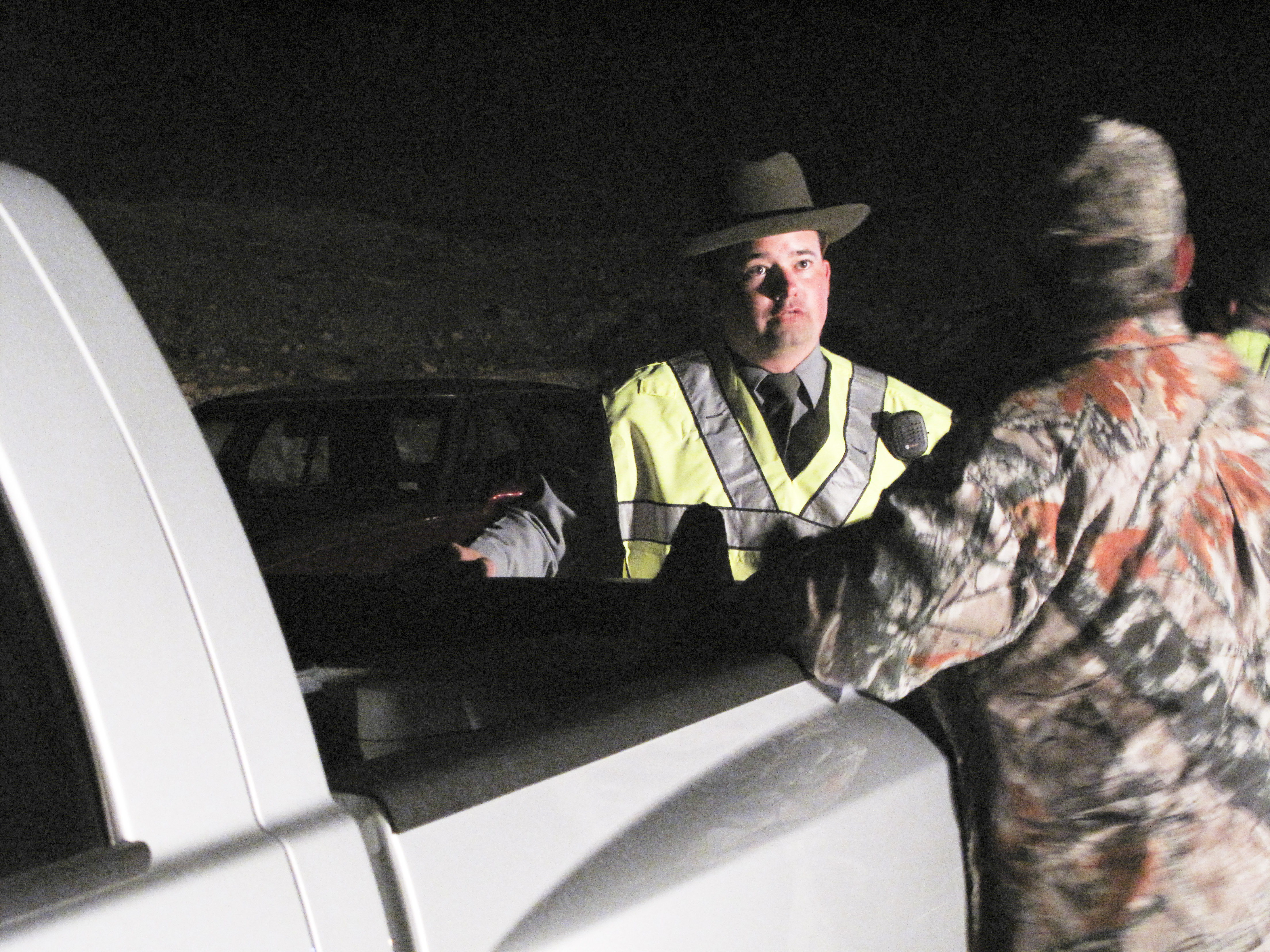 Conservation Agent Brian Towe talks with a deer hunter 