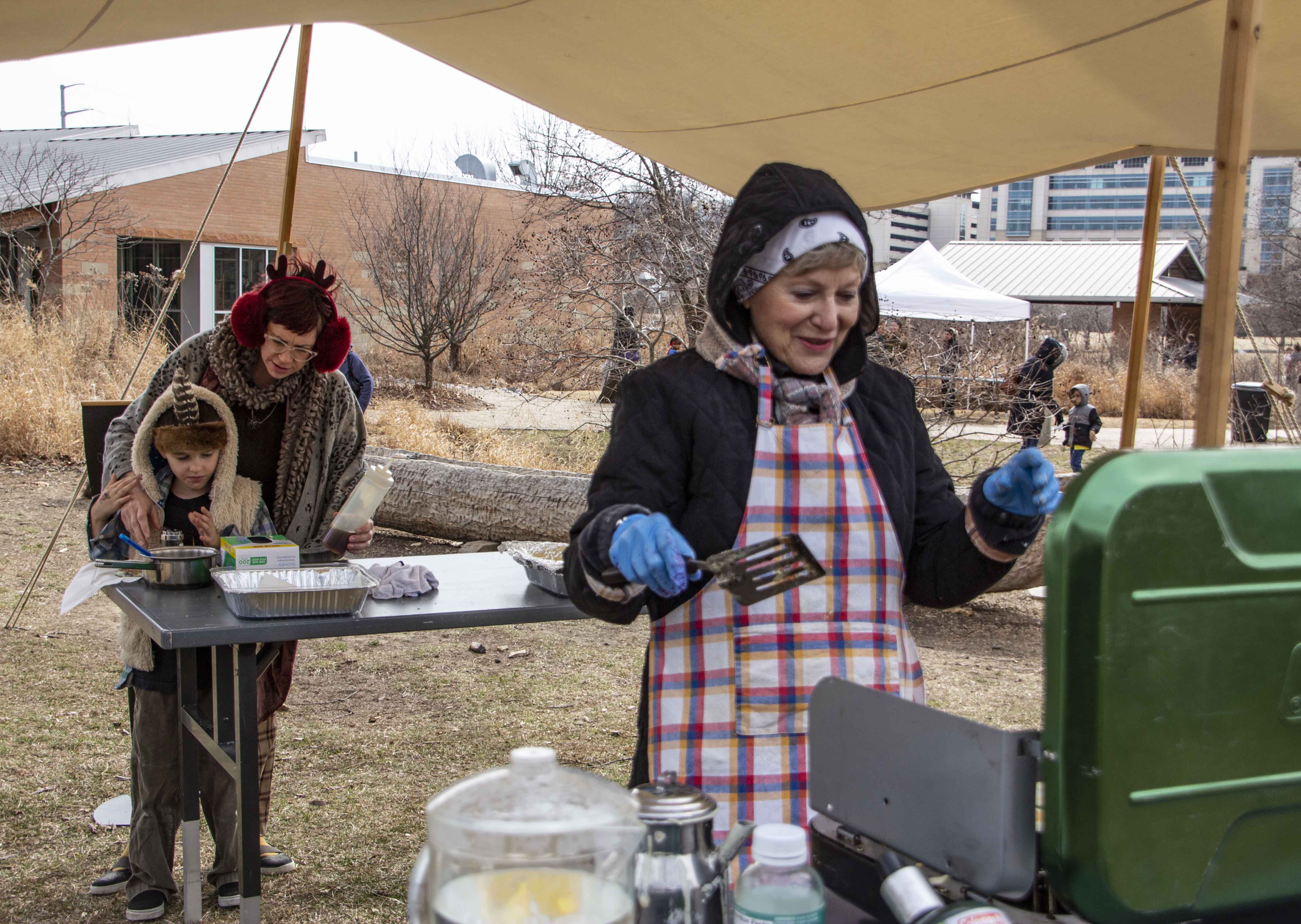 Volunteer Carol Smith cooking pancakes at an Urban Woodsman event last February at the Discovery Center in Kansas City.