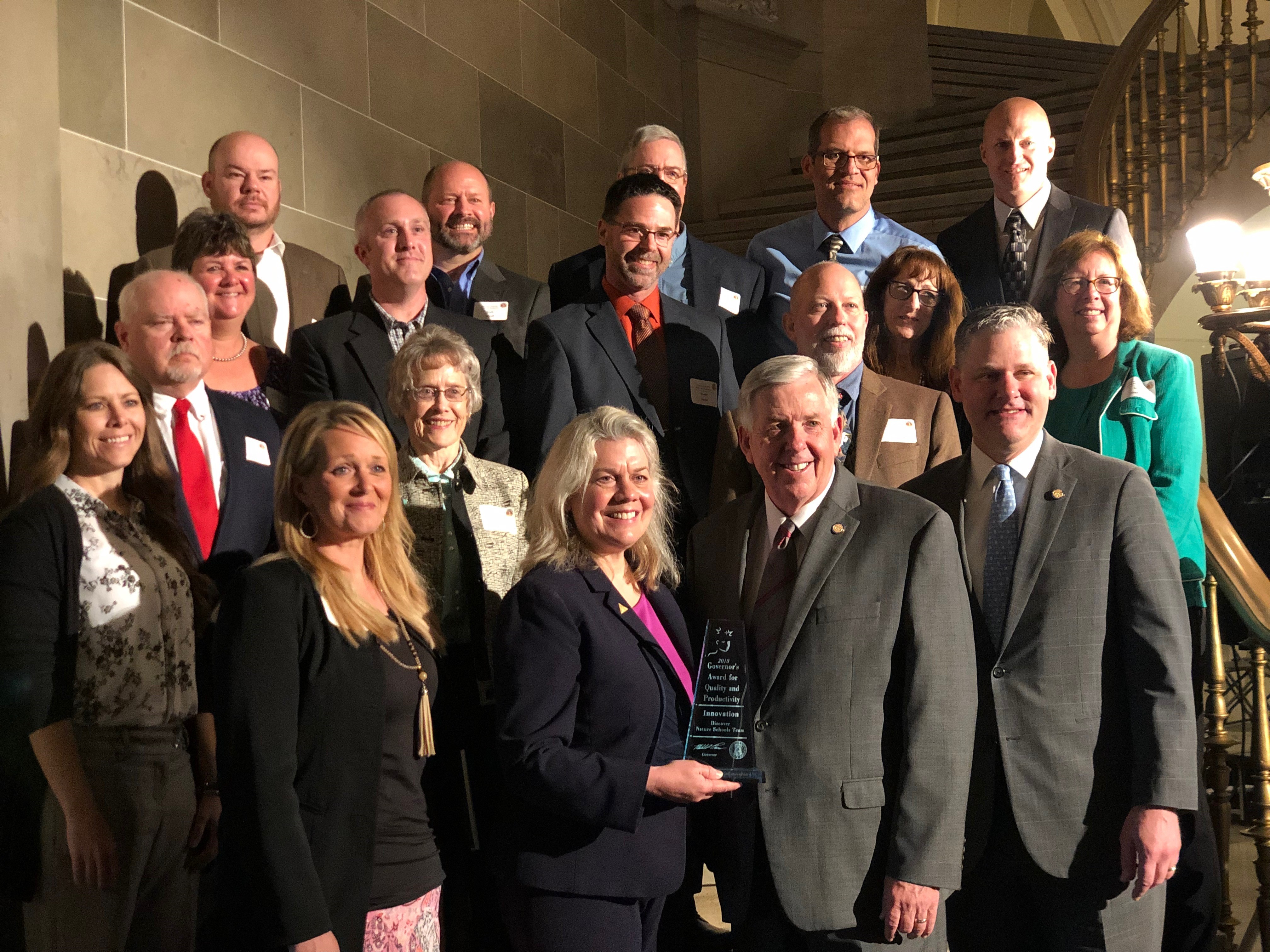 MDC Director Sara Parker Pauley poses with Governor Mike Parson and the DNS team after they received the Governor's Award for Innovation.