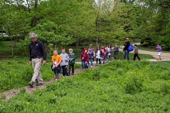 MDC staff lead children on a nature walk at the Discovery Center.