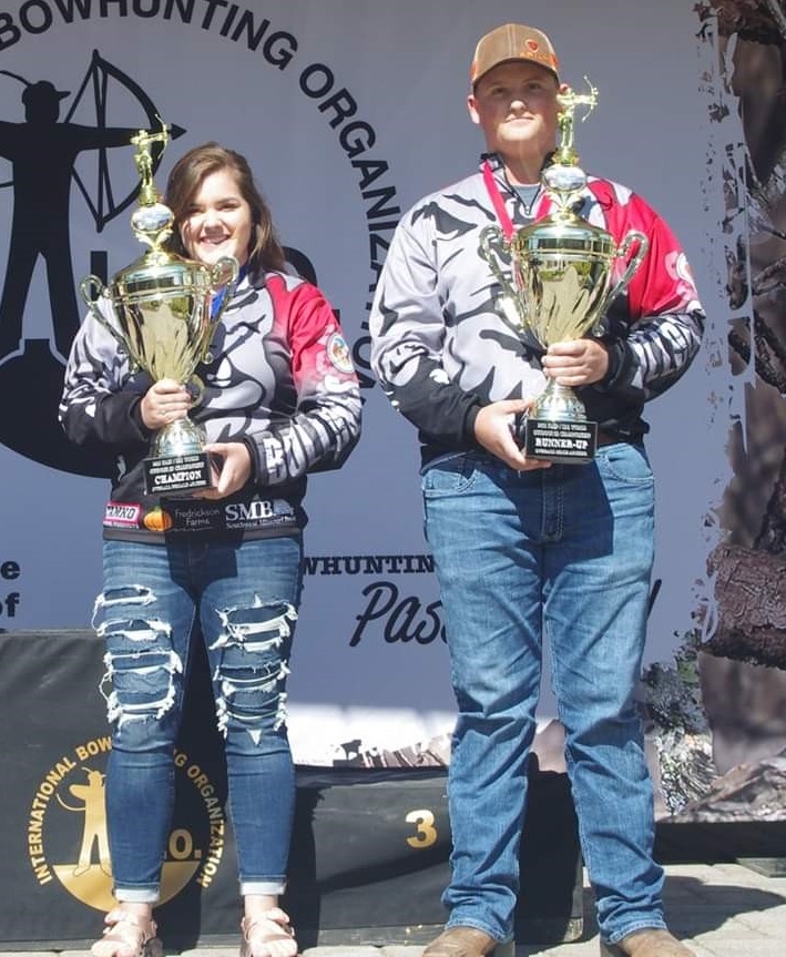 Ivy Walton and Jeremiah Jones pose with their trophies during the NASP/IBO Outdoor World Championship.