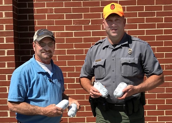 Paul Arnold with Mississippi Lime Company and Conservation Agent Rob Sulkowski pose with Share the Harvest donations.