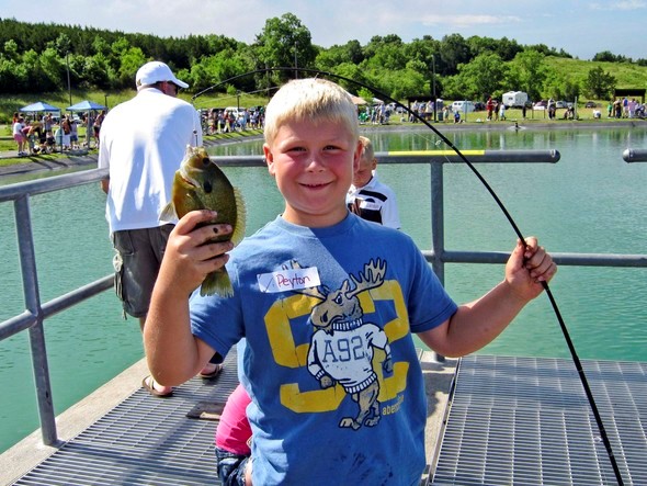 A boy holds a sunfish