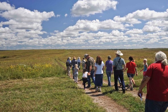 A group of participants tour a prairie in El Dorado Springs.