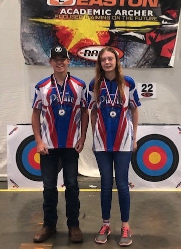 Savannah Sadler and Christopher Edwards pose with their medals during the NASP Open Tournament.