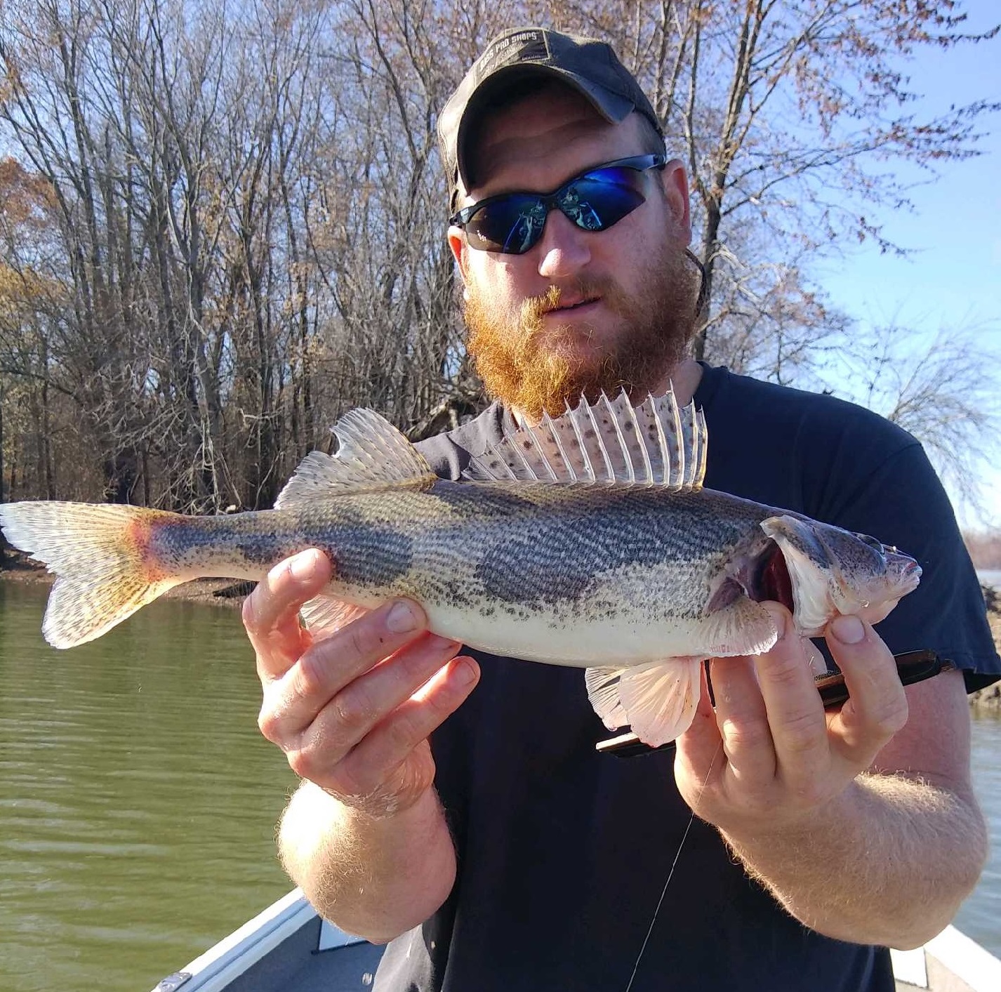 Bryant Rackers poses with his state record sauger caught by alternative methods.