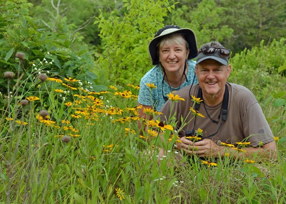 Steve Craig and Amy Short pose in a butterfly garden.