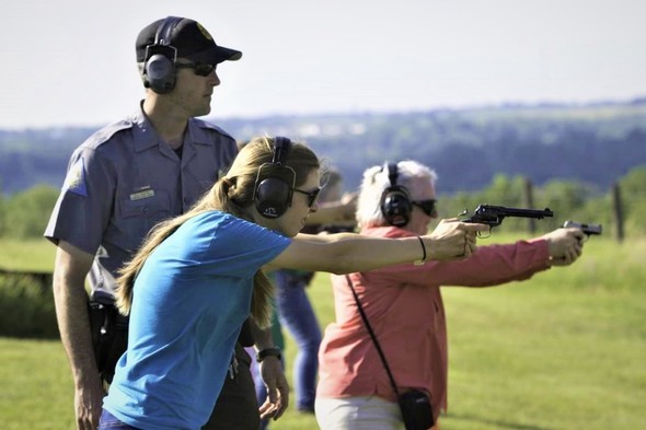 agent teaches handgun safety techniques to two women
