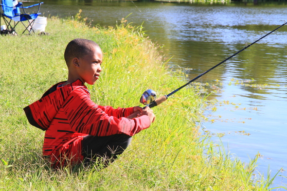 boy fishing on bank