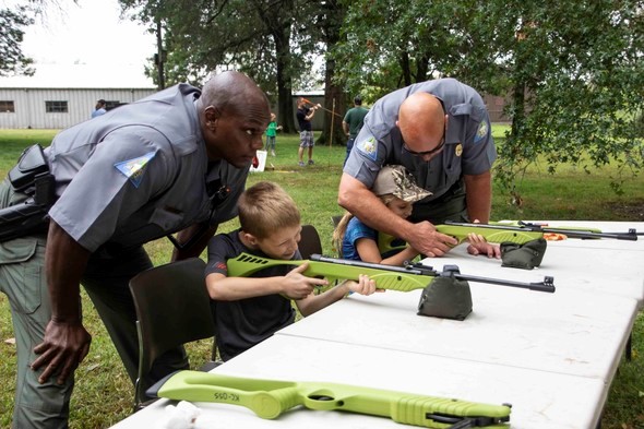 agents help two kids shooting pellet guns