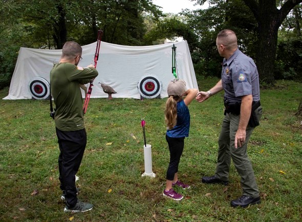 agent shows kids how to shoot target archery