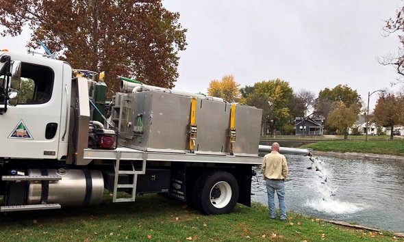 trout stocking from truck at Sedalia's Liberty Park Pond