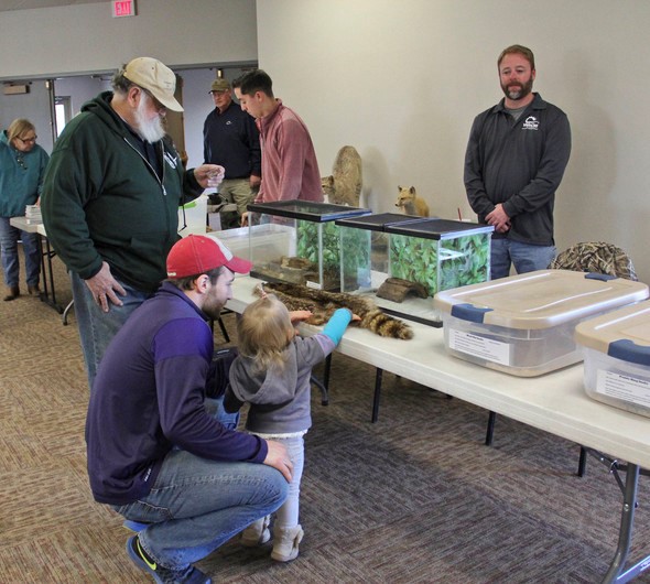 Visitors at Paradise Pointe Golf Course Complex view wildlife displays.
