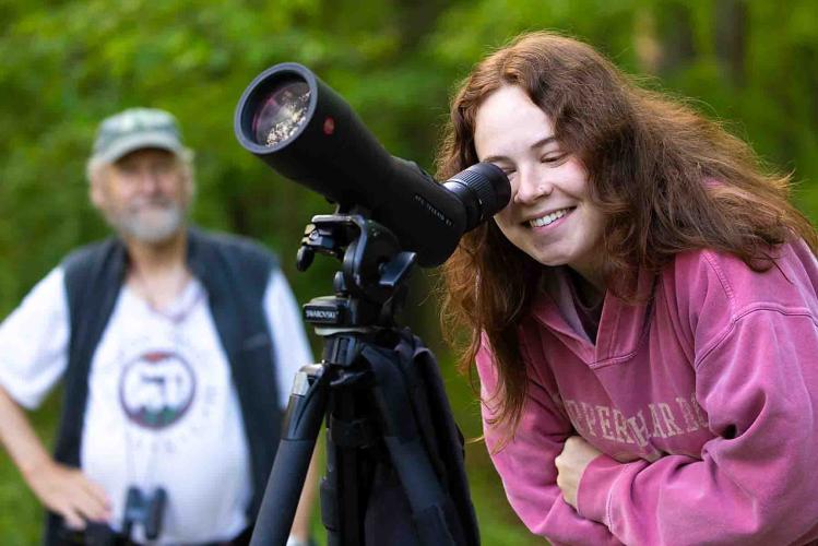 Girl looking through a telescope