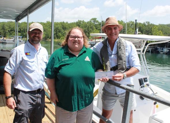 Check presentation from MDC staff to two people at Harbor Marina in Branson