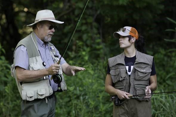 fly fisherman teaches another fly fisherman