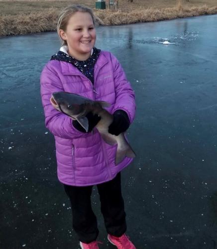 girl holding catfish