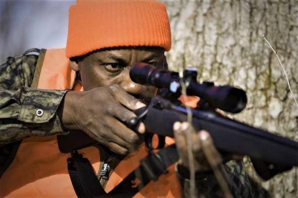 hunter aiming rifle