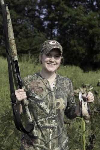 A female hunter shows off a bird she harvested.