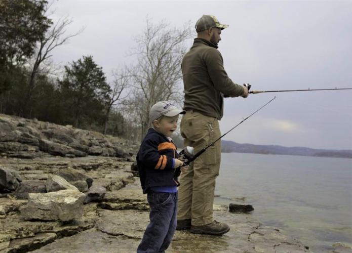 man and boy bank fishing