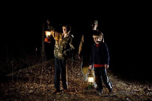 A father and two sons take a guided night hike at Mark Youngdahl Conservation Area in St. Joseph.