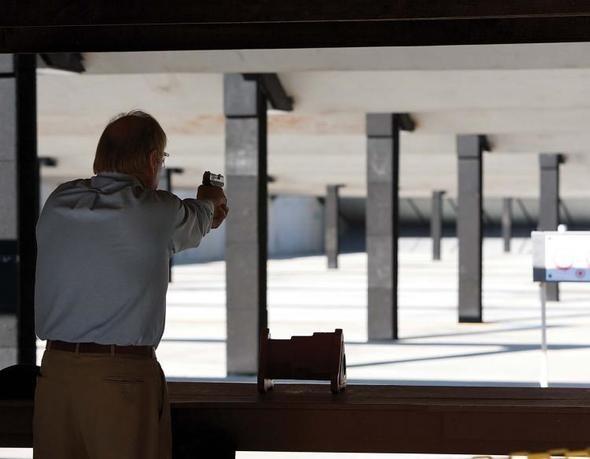 man shooting pistol at range