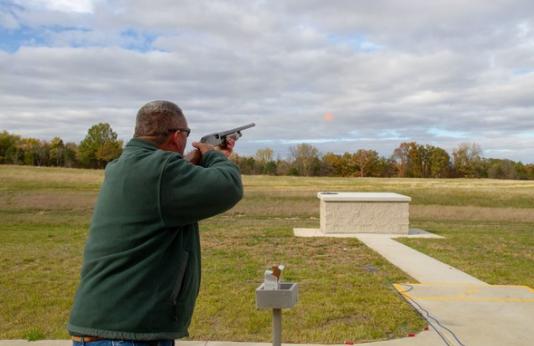 Man practices clay shooting at range