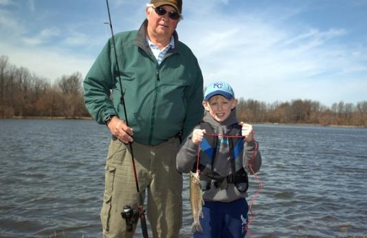 Grandpa and grandson with trout