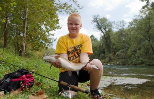 Boy holds trout
