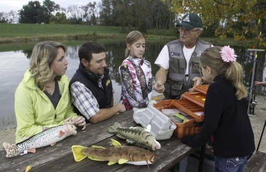 Volunteers teach family to fish