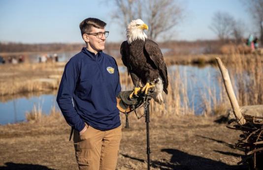 Handler holds bald eagle