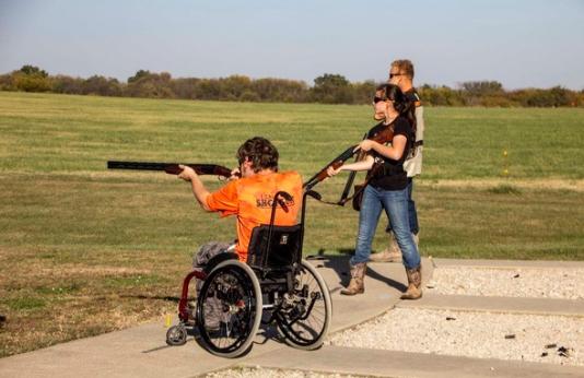 Man in wheelchair uses shotgun for trap shooting
