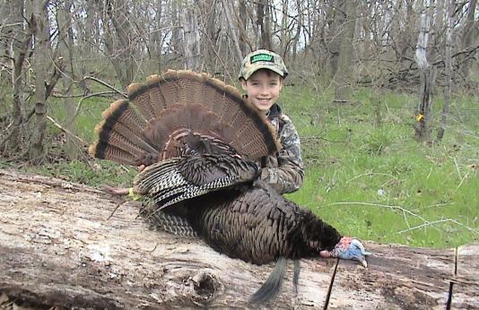 Young turkey hunter with gobbler