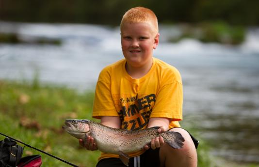 Kid with rainbow trout