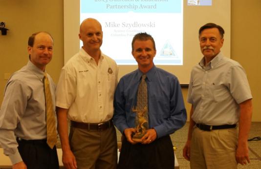 Mike Szydlowski accepts MDC O&E Partnership Award
