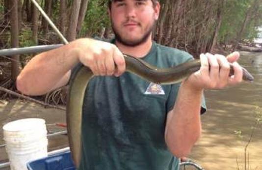 MDC Andy Bueltmann holding an eel.