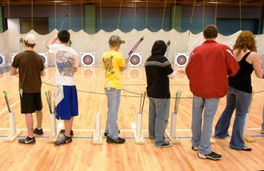 Student archers shooting bows.