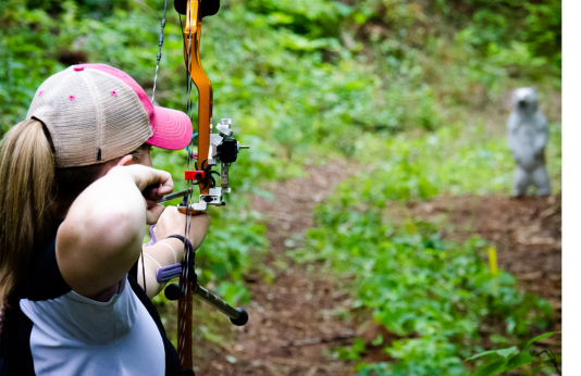 Woman shooting 3D archery