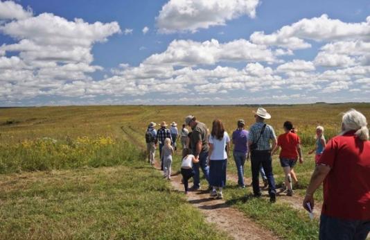 Several people take a guided tour of Dunn Ranch Prairie.