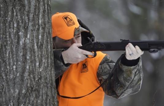 Guy hunting with a muzzleloader.
