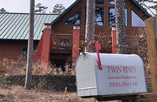 Twin Pines Conservation Education Center mailbox with building behind