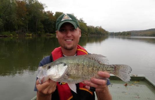 MDC employee holding a crappie.