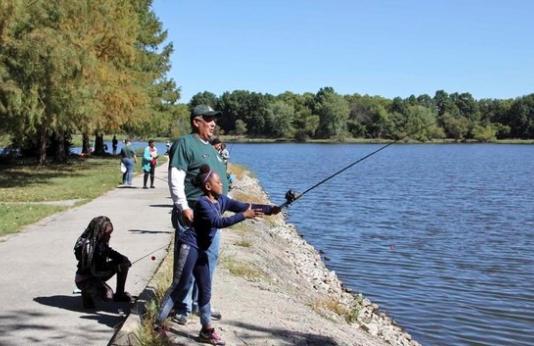 Two girls practice their fishing skills at a Missouri lake.