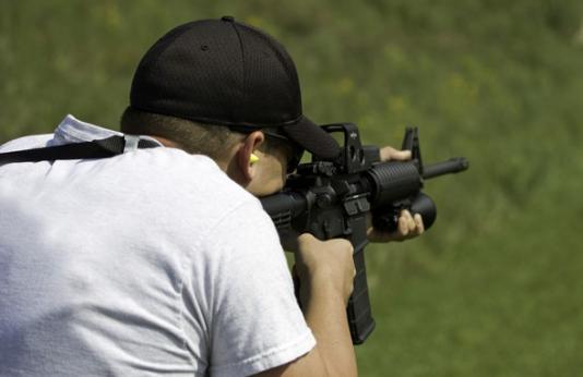 man shooting AR-15 style rifle