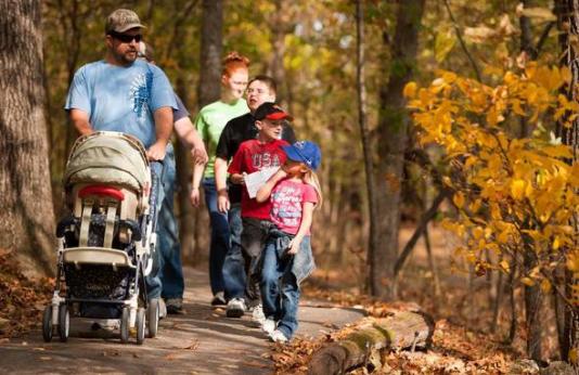 A family takes a nature walk at the Springfield Nature Center.