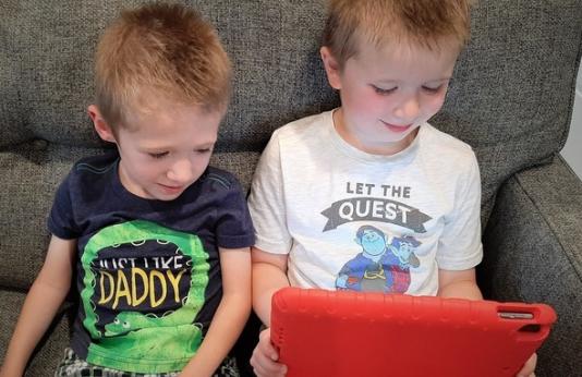 two kids looking at tablet