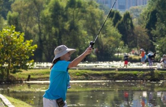 woman fishing at urban lake